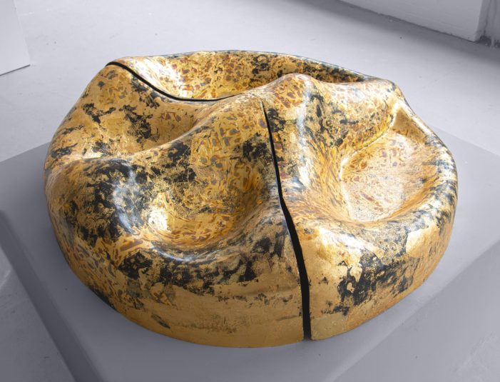 The image shows the sculpture Peace of land by the Greek sculptor Anastasios Nyfadopoulos. The materials of the sculpture are basalt fiber, brass and plant-based resin.