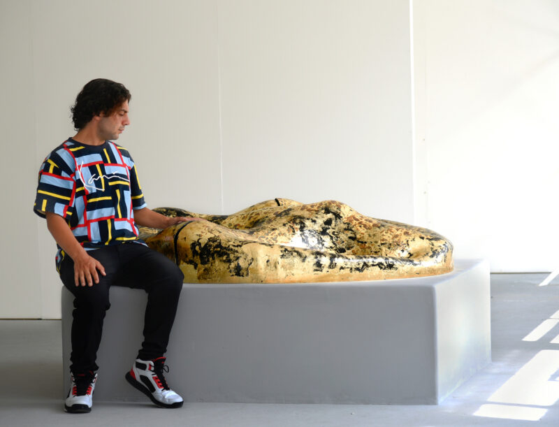 The artist Anastasios Nyfadopoulos with his sculpture "Peace of land"